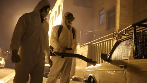 Iranian firefighters disinfect streets in Tehran to halt the wild spread of coronavirus in March 2020
