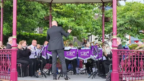 Newbury Town Council Cove Brass performing on the Bandstand in Victoria Park Newbury in June 2028.
