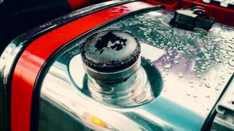 Getty Images Shiny metal lorry fuel tank showing fuel cap