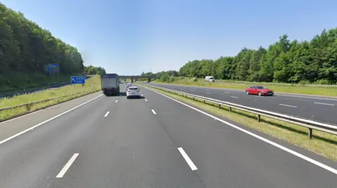 Google The M6 motorway with multiple cars driving down.