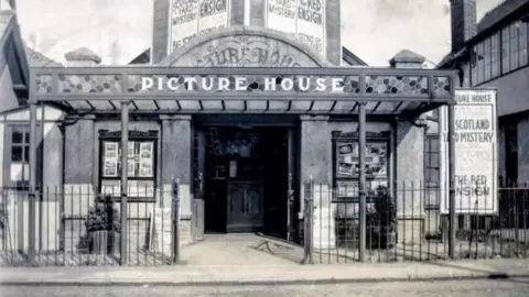 Save Novello Picture House An old black and white image shows the front entrance of the Picture House