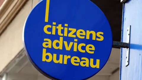 A round Citizens Advice Bureau sign. It is blue with yellow text.