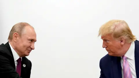 Reuters Russian President Vladimir Putin and U.S. President Donald Trump, both wearing suits and ties, look at each other against a white background during the 2019 G20 Summit in Osaka, Japan