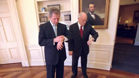 Getty Images George W. Bush and Dick Cheney check their watches in the Oval Office