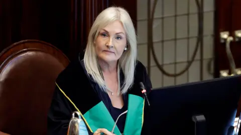 PA Media Ceann Comhairle, Verona Murphy TD, in the Dail chamber. She has blonde hair and wearing her speaker robes.