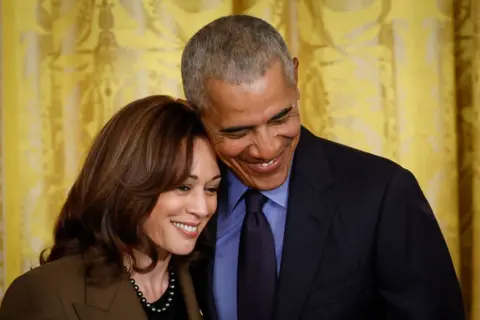 Getty Images Barack Obama and Kamala Harris smile together at a White House event in 2022 to mark the anniversary of the signing of the Affordable Care Act.