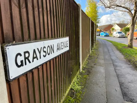 Shaun Whitmore/BBC The road sign for Grayson Avenue, Pakefield, Suffolk