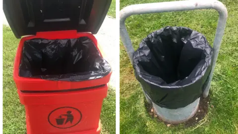 Trinity Estates Two pictures side by side. On the left there is an empty red dog waste bin with its lid open. On the right there is a general waste bin with its outside cover removed showing it has been emptied.
