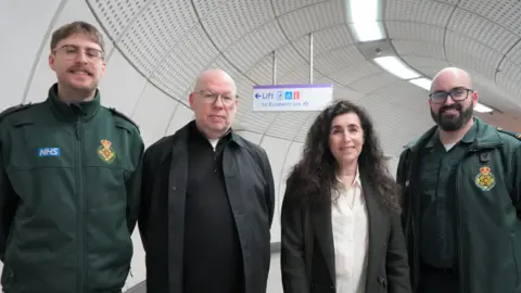 Paul and Lorraine with paramedics Jackson and Luke on either side of them 