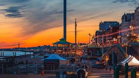 Tadas Kaminskas An orange and blue sky over brighton.