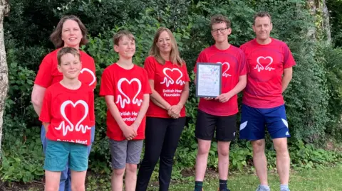 British Heart Foundation Nick and his family all wearing red British Heart Foundation t-shirts.