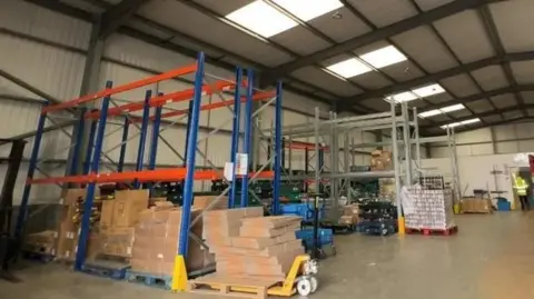 Caroline Bilton/BBC News A photo of a warehouse with food supplies