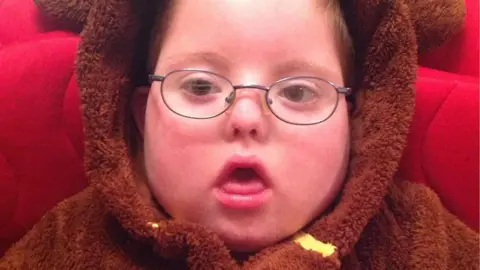 Children’s Hospice South West Jack wearing a fluffy brown dressing gown