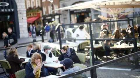 Reuters People eating outside in Covent Garden