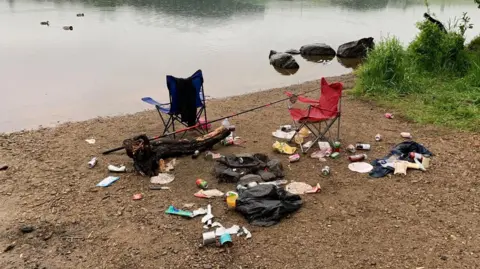 Emily Crichton Piles of rubbish and discarded camping equipment on the banks of a loch