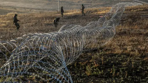 EPA Ukrainian soldiers installing anti-tank landmines and non-explosive obstacles along the frontline at an undisclosed location near Chasiv Yar, Donetsk region, eastern Ukraine.
