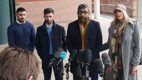 PA Media Mohammed Ramzan (second right), addresses the media outside Preston Crown Court