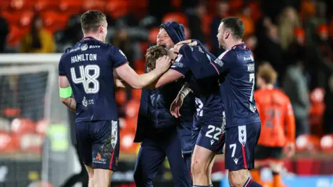 Dundee celebrate their derby victory at Tannadice