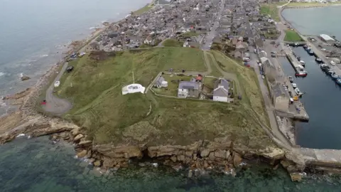 Aerial view of the village of Burghead on a promontory jutting out into the Moray Firth.