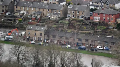 Getty Images General view of properties that were flooded as residents begin clearing up following severe flooding beside the River Calder