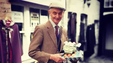 Wilf holding cartons of eggs