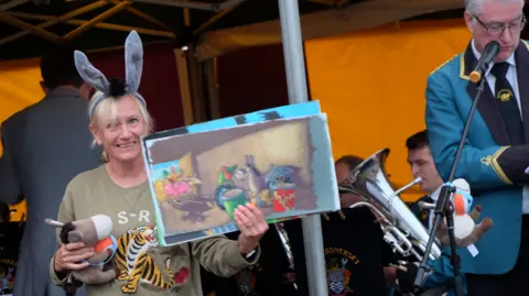 West Somerset Brass Band Jill Newton holding her book in front of the band