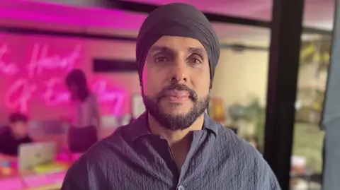 Gurch Singh wearing a black turban and shirt