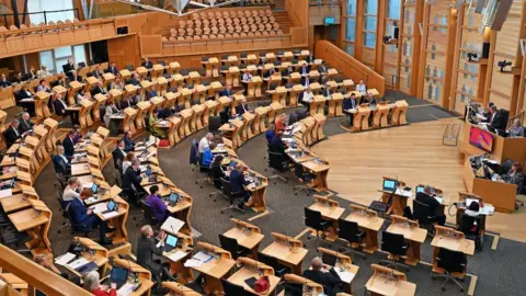 Wide shot of MSPs in the Scottish Parliament chamber 
