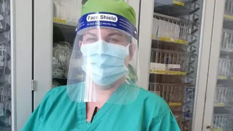 Claire Leyland Claire Leyland wearing a surgical mask and face visor