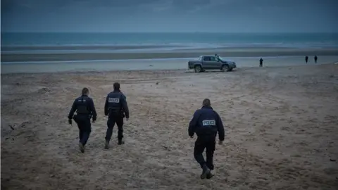 Getty Images French police patrol the beach of Wimereux searching for migrants on November 25, 2021 in Calais, France