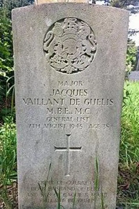 Friends of Cathays Cemetery A roughly 3ft high headstone bearing his name and military achievements. At its top is a carved representation of the Royal Coat of Arms emblem, showing a lion and unicorn 