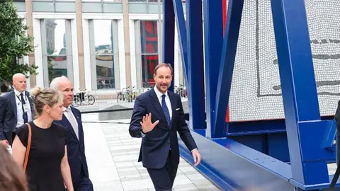 NTB / AFP via Getty Images Crown Prince Haakon of Norway gestures to a crowd. Photo: July 2026