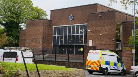 PA Media The scene at Heaton Park Hebrew Congregation synagogue in Crumpsall, Manchester, where two people died in the attack.