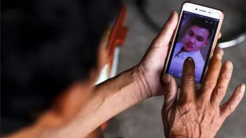 Reuters The father of Hoang Van Tiep shows his picture on a mobile phone