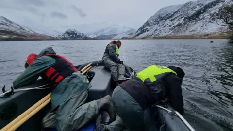 West Cumbria Rivers Trust West Cumbria Rivers Trust and National Trust staff surveying for New Zealand Pigmyweed in Crummock Water in the winter