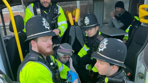 The BBC man was arrested by four police officers and then put into a police van where other protesters were sitting.