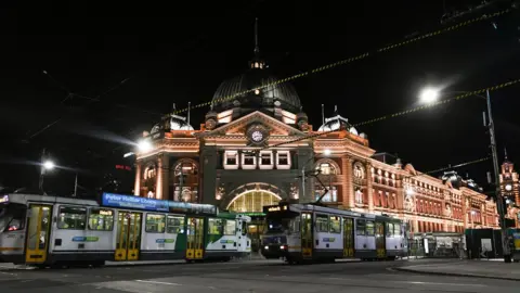 EPA Deserted street outside Flinders Street Station at night