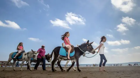 PA Media A donkey ride on Scarborough beach