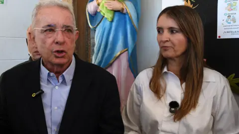 Getty Images Colombia's former president (2002-2010) Alvaro Uribe (L) arrives to vote at a polling station accompanied by Colombia's presidential candidate Paloma Valencia.
