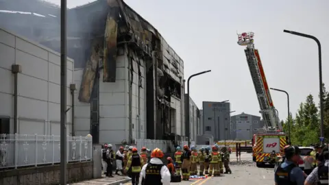 Reuters Tens of emergency work at the site of a deadly fire at a lithium battery factory owned by South Korean battery maker Aricell, in Hwaseong, South Korea, June 24, 2024.