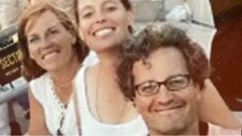 Anne Fogel Family photo of Marc Fogel smiling with his sisters Anne and Lisa