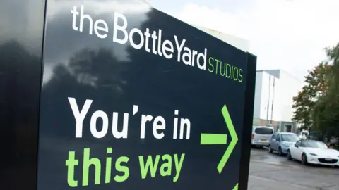 The Bottle Yard Studios The sign outside the entrance to the studios. It says The Bottle Yard Studios, You're in, this way and has an arrow pointing inwards