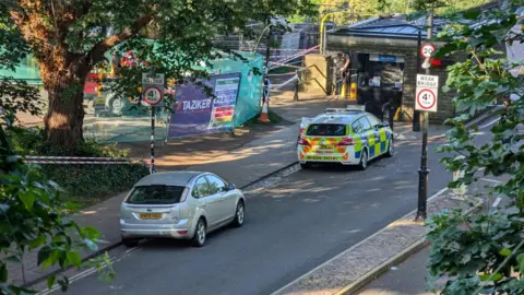 Police car and cordons around the bridge