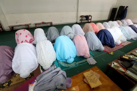 EPA Students pray together in a row