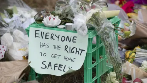 EPA A sign left among tributes to murdered student Aya Maasarwe reads 'Everyone has the right to get home safely'