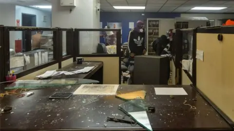 AFP Anti-government demonstrators loot and later destroy the property of a branch of the Banco Provincial bank which works inside the administration headquarters of the Supreme Court of Justice after attacking and invading the building as part of protests against President Nicolas Maduro in Caracas, on June 12, 2017.