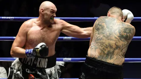 Tyson Fury lands a punch on Mariusz Wach