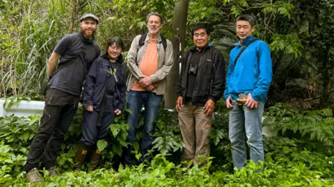 Dan Crowley The five members of the research team in outdoor clothing in a forest area