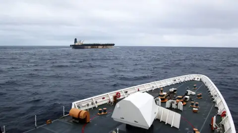 The shadow fleet ship Marinera seen in the distance from the upper decks of a US coastguard cutter following her.