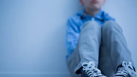 Getty Images A boy sit alones